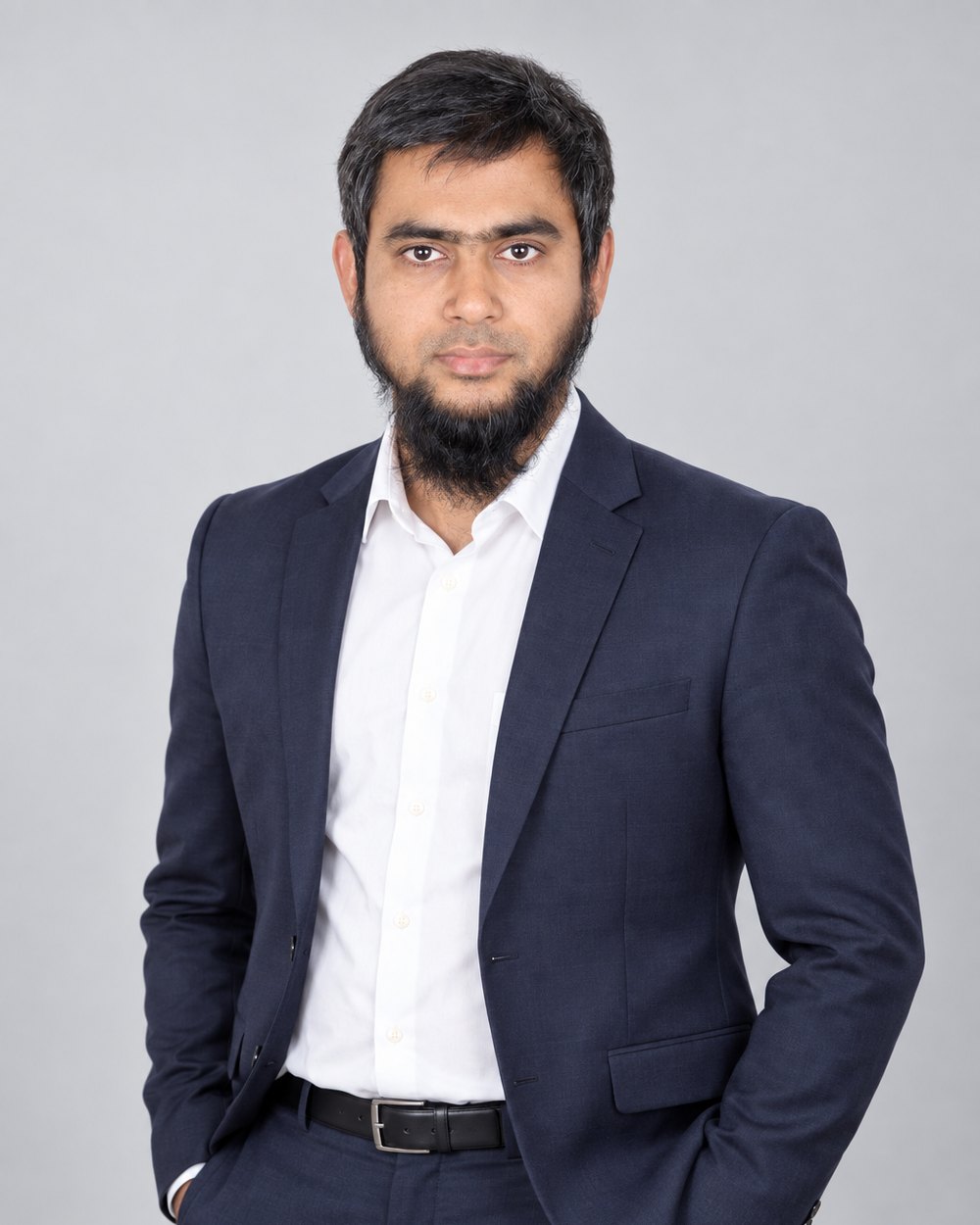 Masud Rana in a navy suit, studio portrait